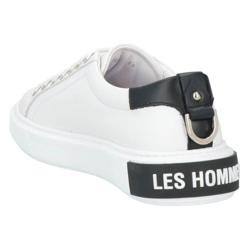 Les Hommes white calfskin men's sneaker with black leather heel, silver logo, and decorative metal ring detail.