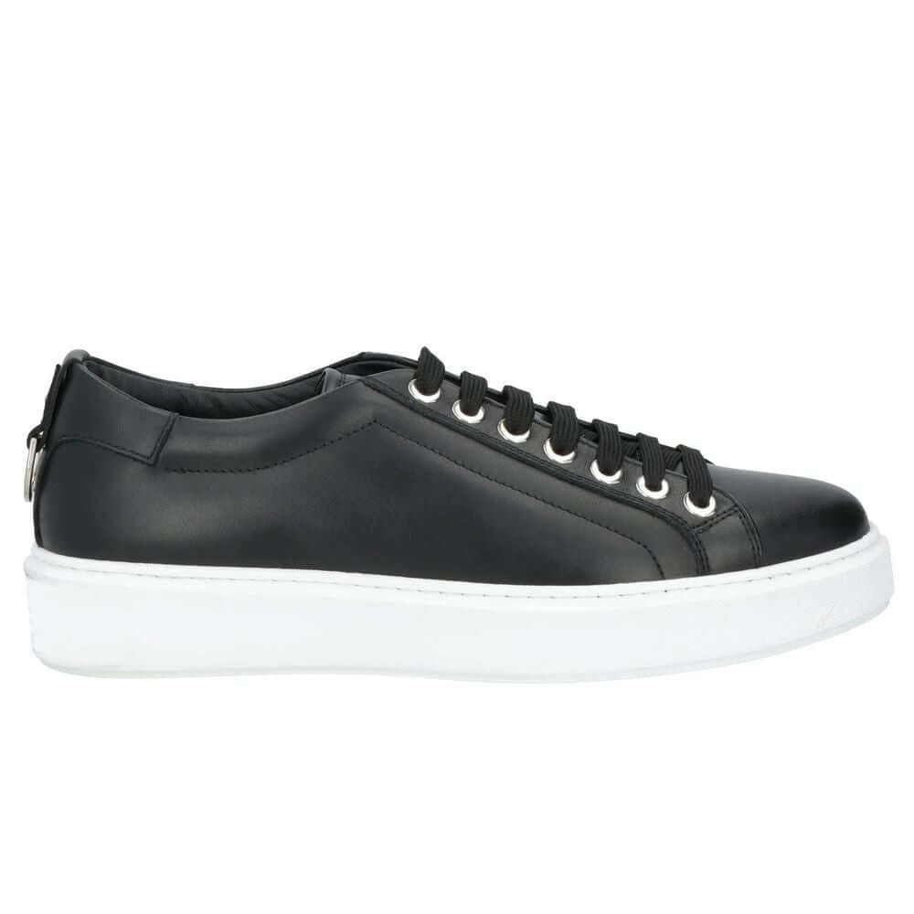 Les Hommes black calfskin men’s sneakers with white sole, silver logo on tongue, and decorative metal ring at heel.
