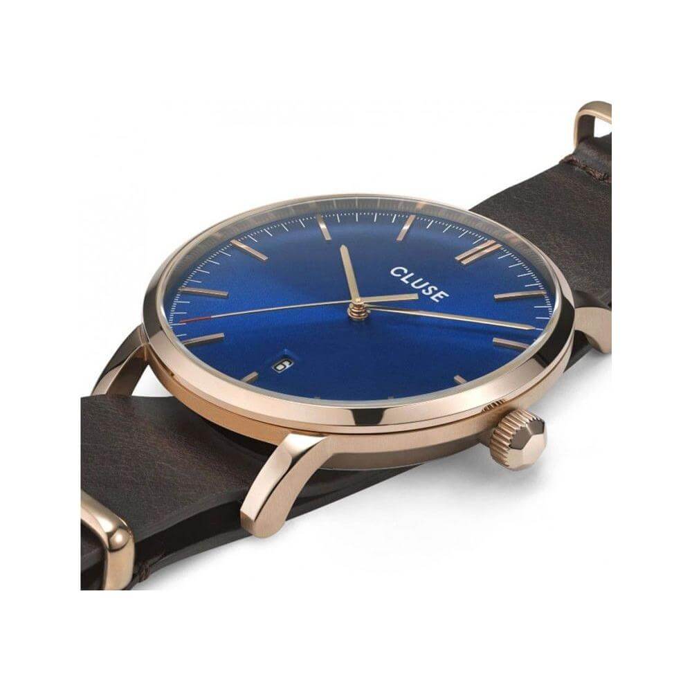 Cluse brown leather watch with blue dial, pink stainless steel case, quartz mechanism, mineral glass, and buckle closure.
