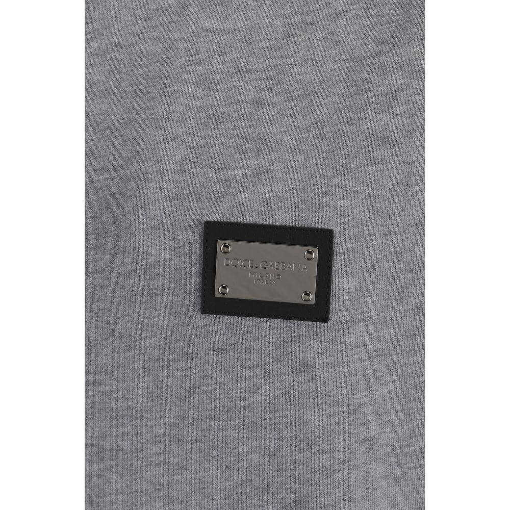 Close-up of Dolce & Gabbana cotton hoodie showing the metal plaque with engraved D&G logo, featuring a classic monochrome design.