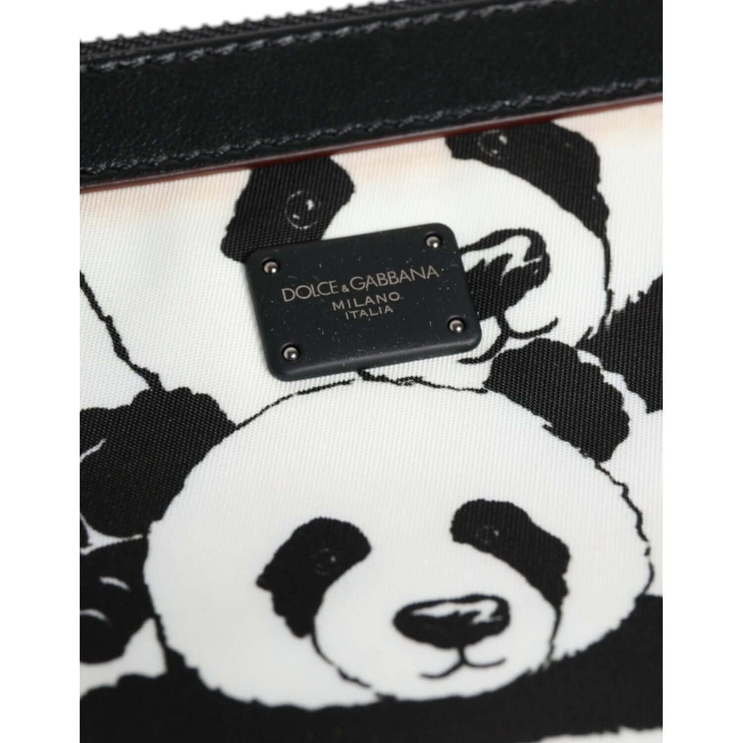 Dolce & Gabbana black and white panda pattern clutch with logo-engraved metal hardware, featuring playful design and luxe detailing.