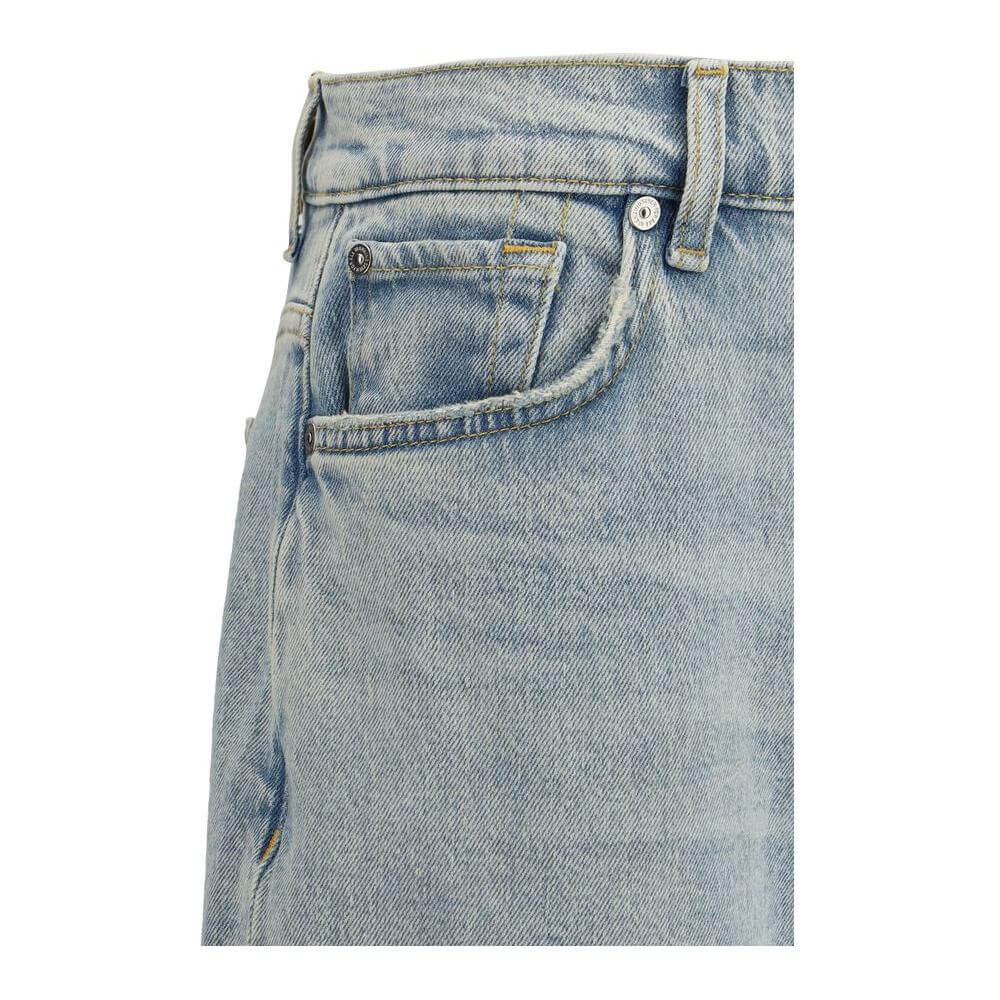 Close-up view of 7FOR Spencer Flare Sahara Jeans mid-rise waist with pocket and belt loops, featuring classic denim texture.
