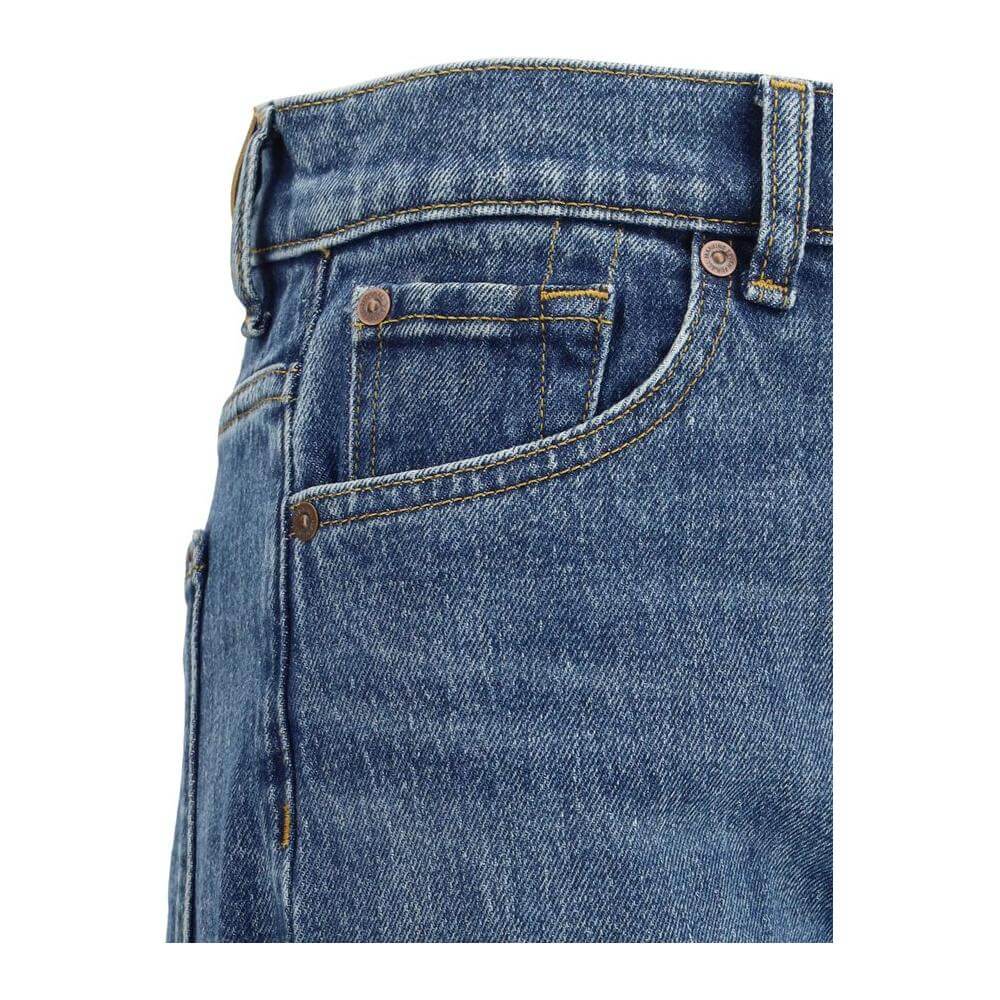Close-up of 7For Jasper Jeans showing five-pocket style with button closure and belt loops, featuring leather signature patch on back.