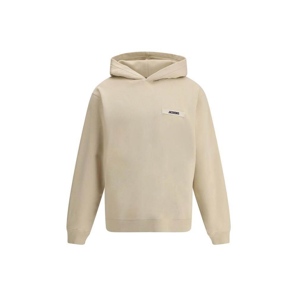 Jacquemus cotton hoodie with plush interior and logo patch, featuring ribbed cuffs and hem for a snug fit, neutral color.
