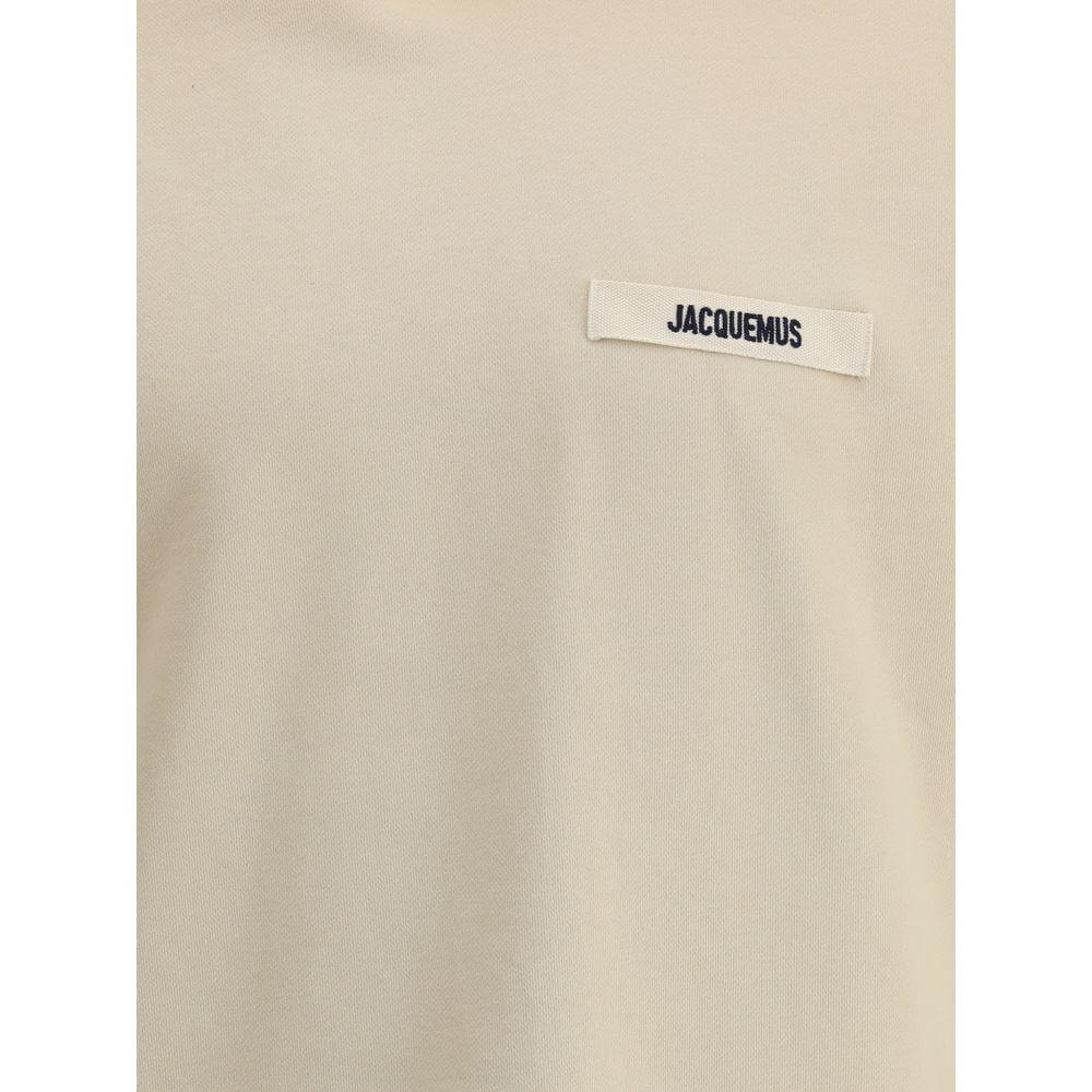 Jacquemus cotton hoodie with plush interior and iconic monogram patch on the front, showcasing ribbed cuffs and hem for comfort.