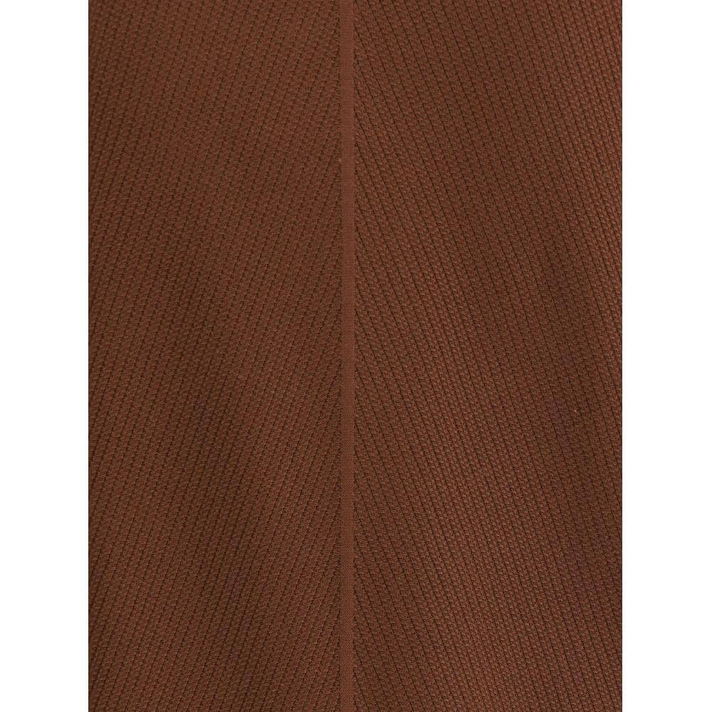 Close-up of Brioni's brown textured knit fabric showcasing the refined details of their polo shirt design.