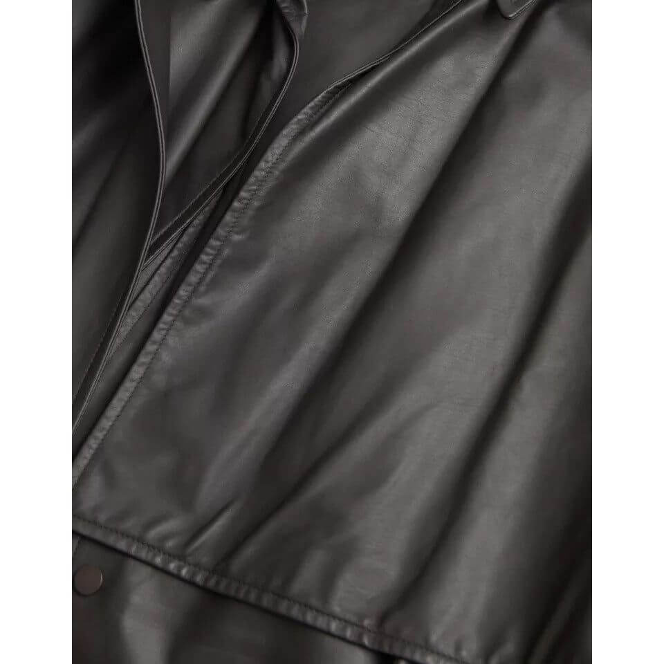 Close-up of Bottega Veneta black leather trench coat, showcasing the smooth, high-quality calf leather texture.