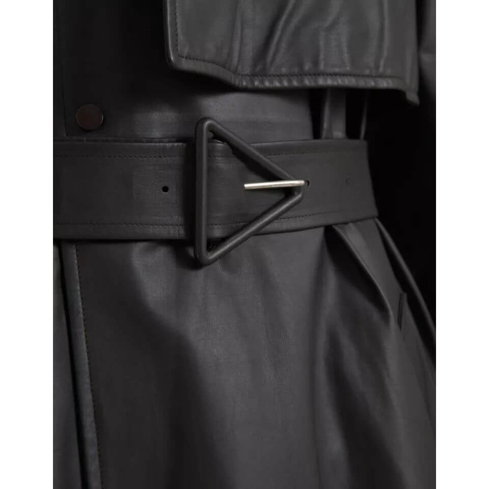 Close-up of Bottega Veneta black leather men's waterproof trenchcoat with triangle buckle detail.
