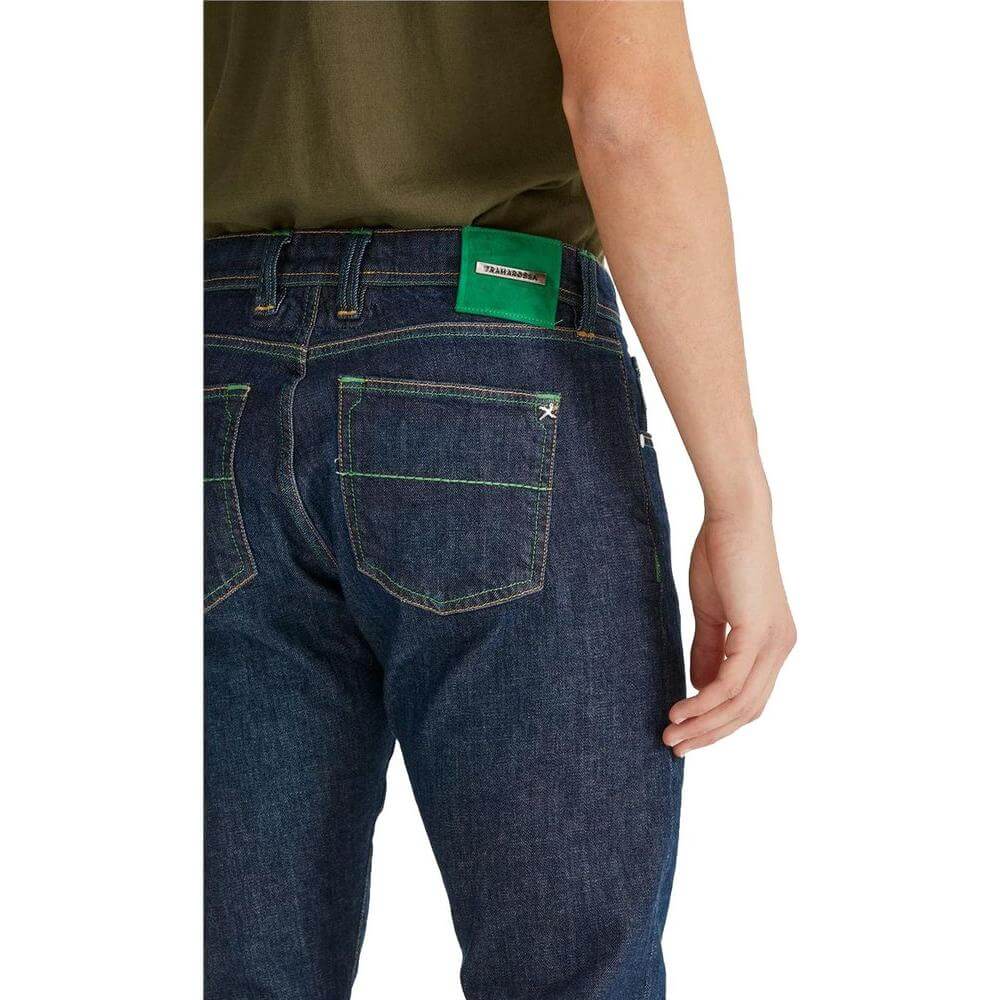 Back view of Tramarossa blue jeans with green stitching and suede patch, featuring metallic logo and five-pocket design.