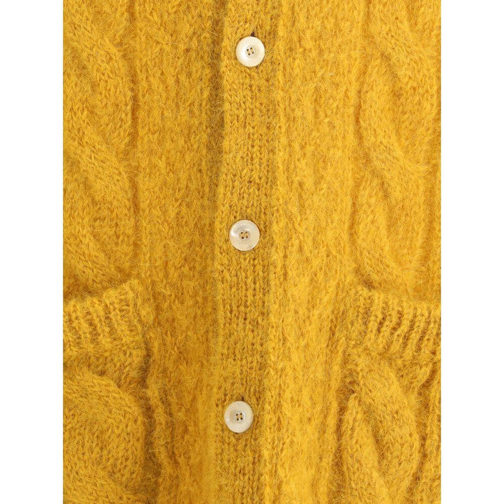 Close-up of Valentino wool maxi cardigan with braided design, front buttons, and patch pockets in warm, sophisticated style.