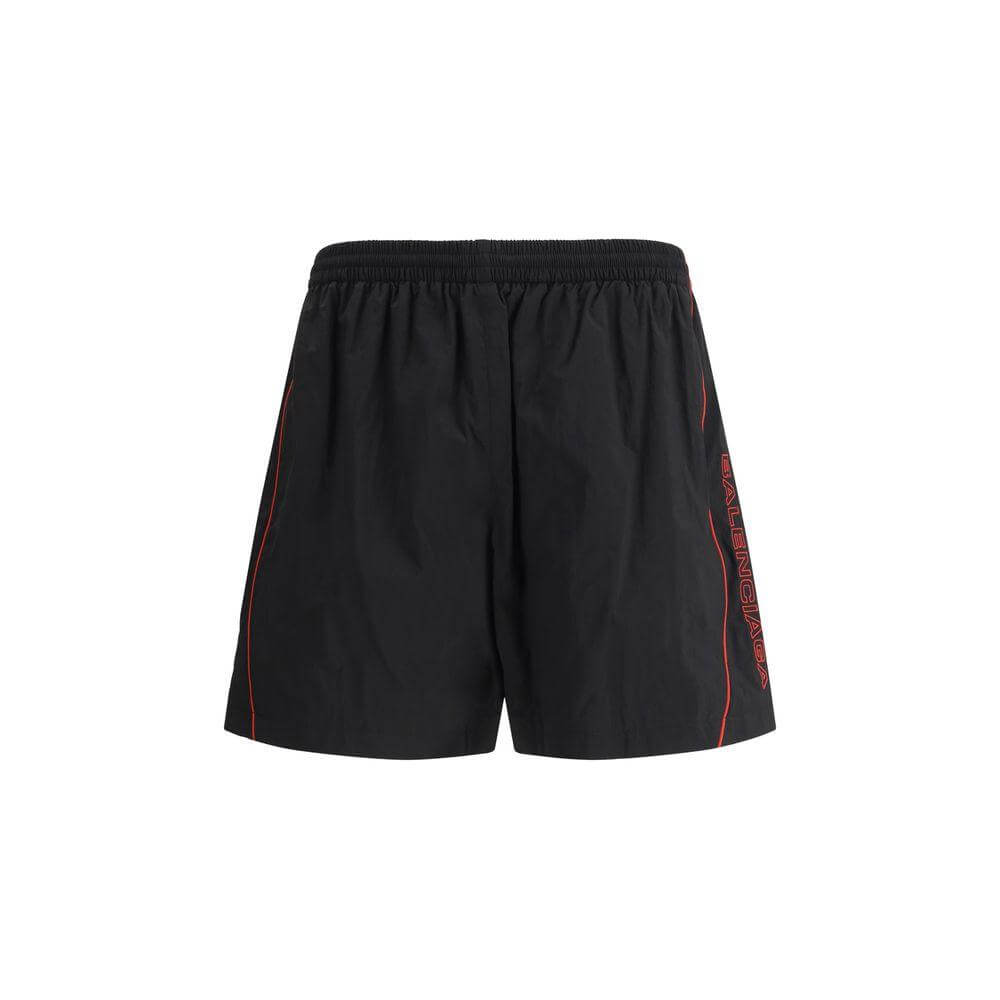 Balenciaga tracksuit shorts with elastic waistband, side pockets, and iconic monogram stitching, shown against a white background.