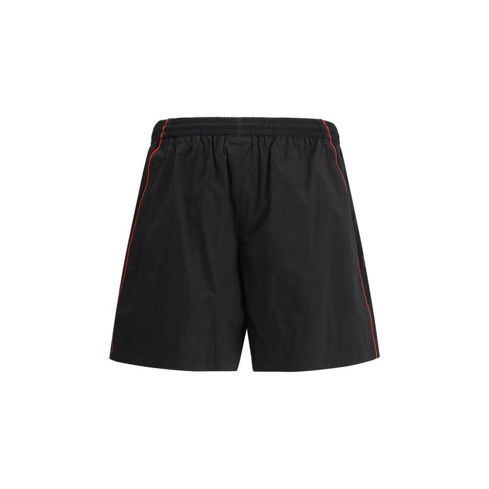 Balenciaga tracksuit shorts in black with elastic waistband, side welt pockets, and signature monogram stitching for a stylish look.