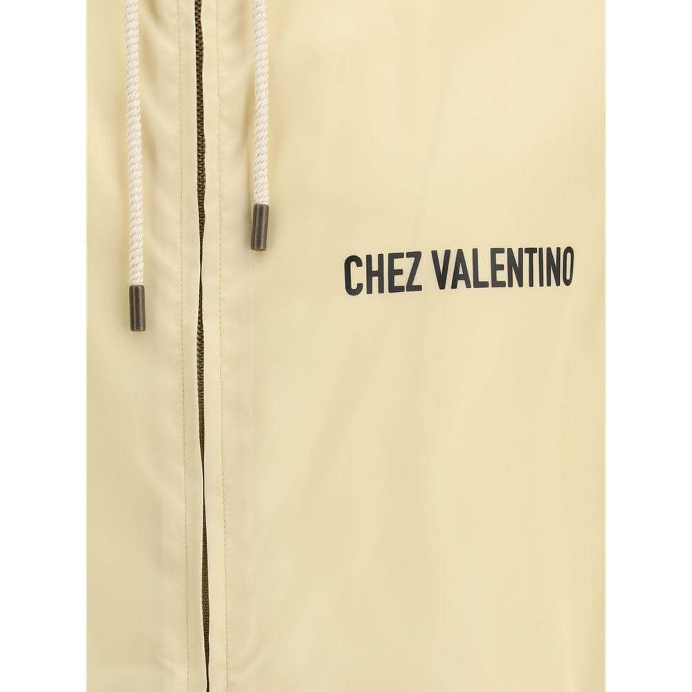 Valentino waterproof jacket close-up featuring zipper and branded monogram with drawstring hood.
