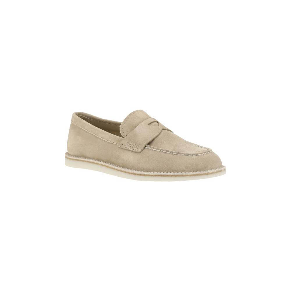 Beige Prada suede loafers featuring an almond toe, sleek design, contrasting flat sole, and logo-embossed insole for a sophisticated look