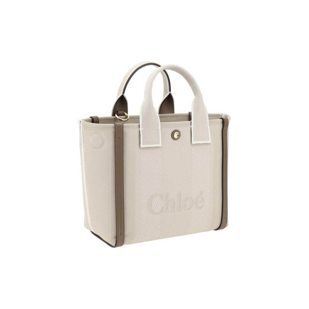 Chloé Carry Tote Bag with cotton body and leather accents, featuring magnetic side buttons, snap top closure, and adjustable shoulder strap.