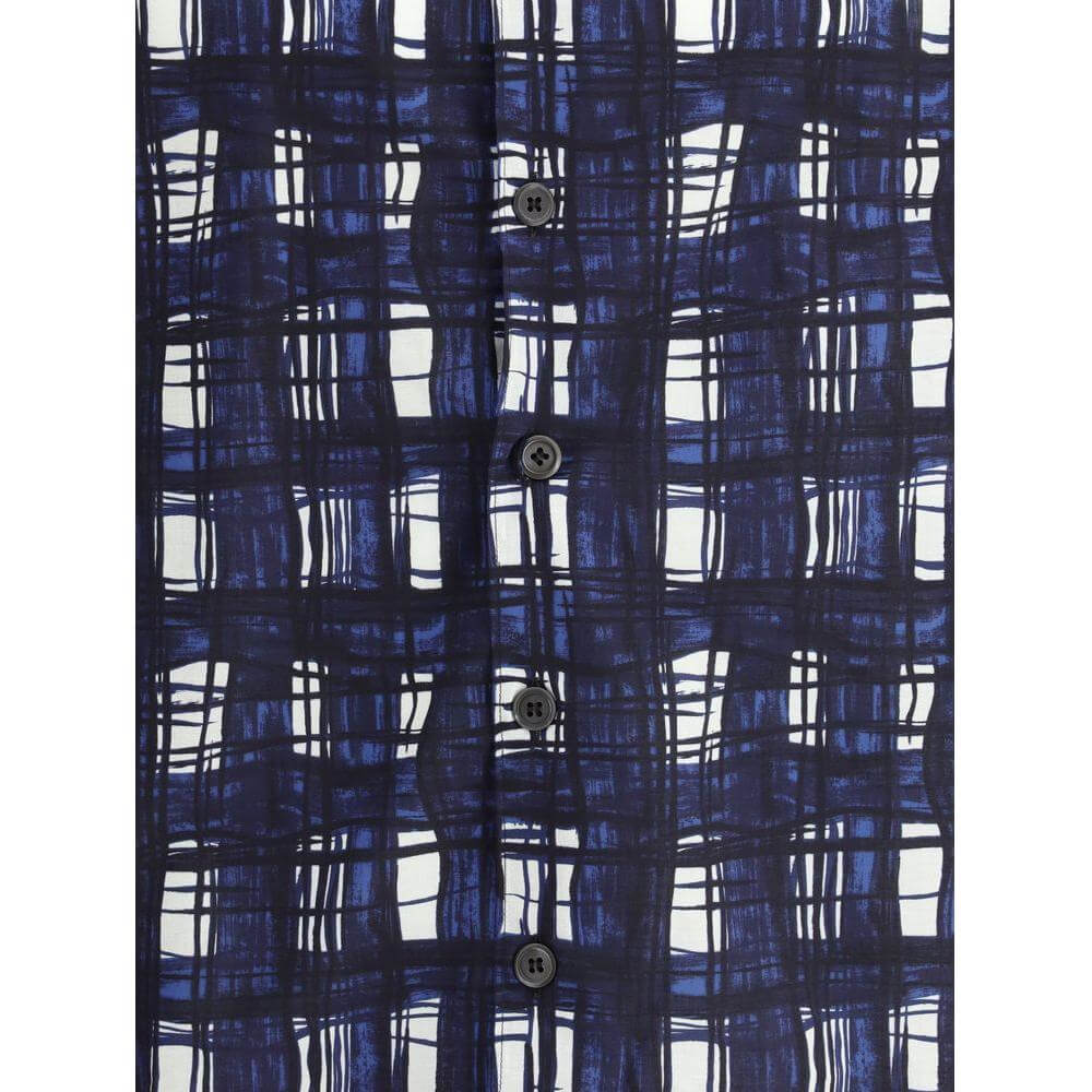 Close-up of Prada Madras check pattern on a cotton shirt with front button closure in navy and white.
