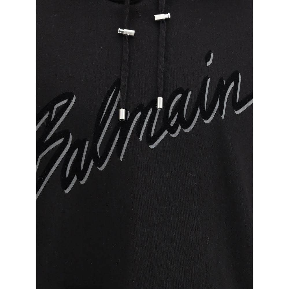 Black Balmain cotton hoodie with iconic logo and adjustable drawstring.