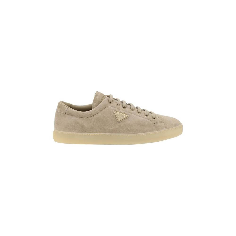 Prada suede sneakers with round toe, front laces, and iconic logoed triangular plaque on side, luxury casual style.