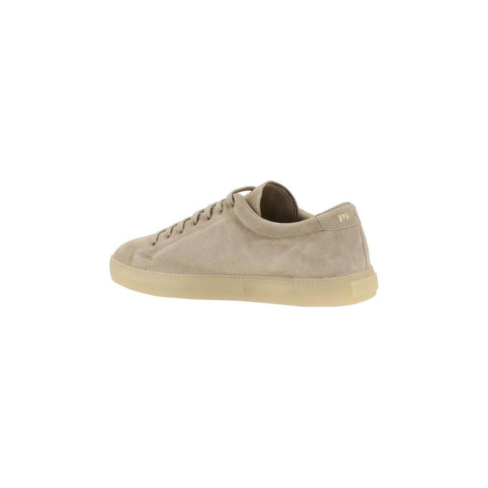 Prada suede sneakers with logoed triangular plaque, round toe, and flat sole, showcasing luxury and casual style from side view.