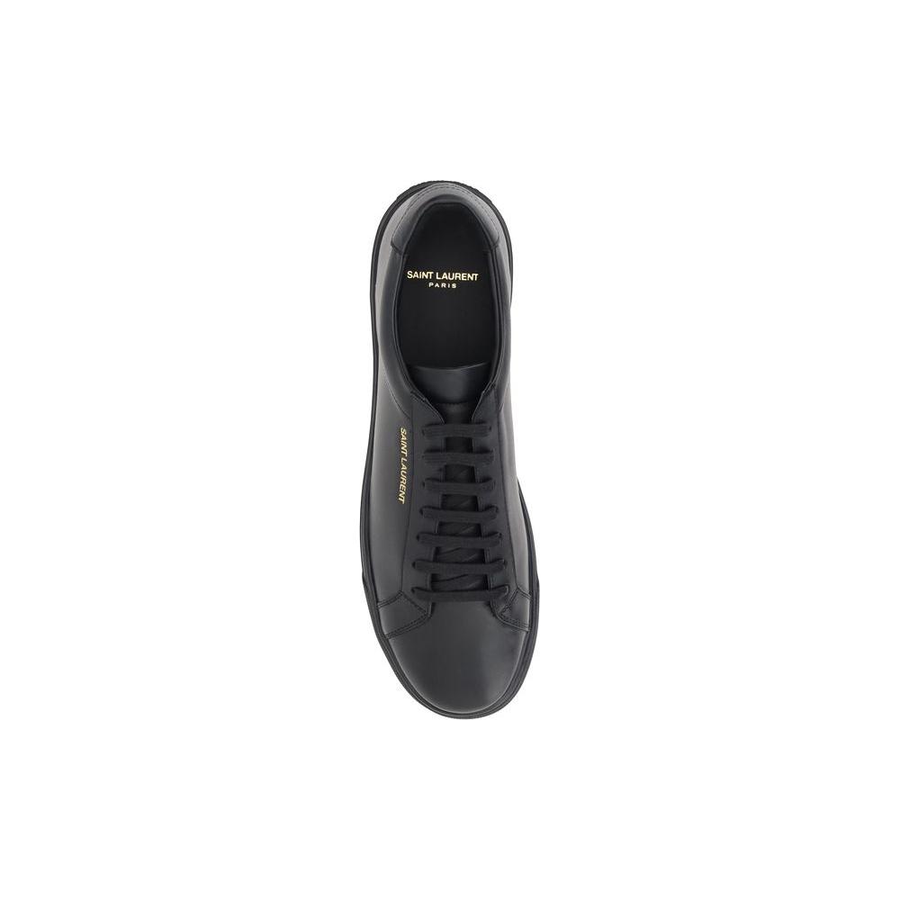 Top view of Saint Laurent black leather sneaker with lace-up closure and gold monogram on the side.