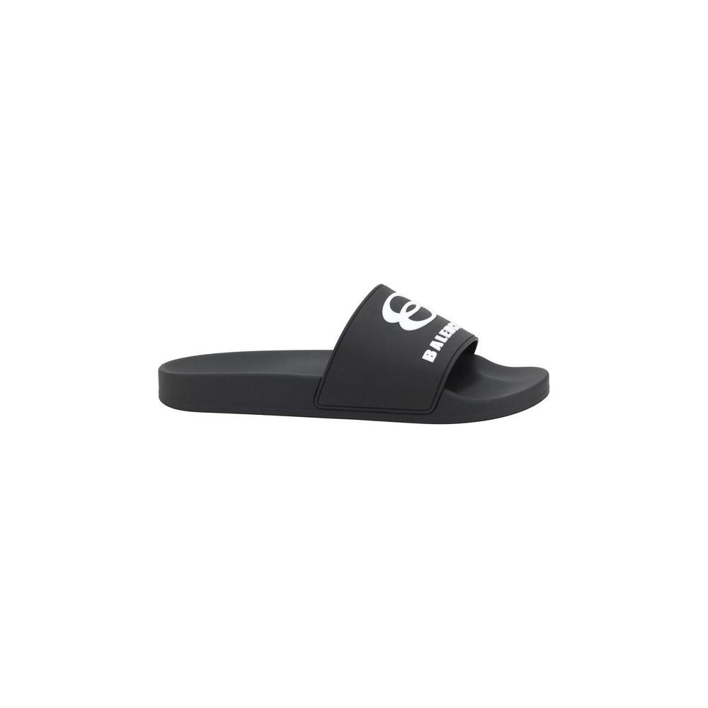 Balenciaga Logo Slippers with embossed logo on band, round toe, and flat sole for elegance and comfort. Ideal for a sophisticated casual look.
