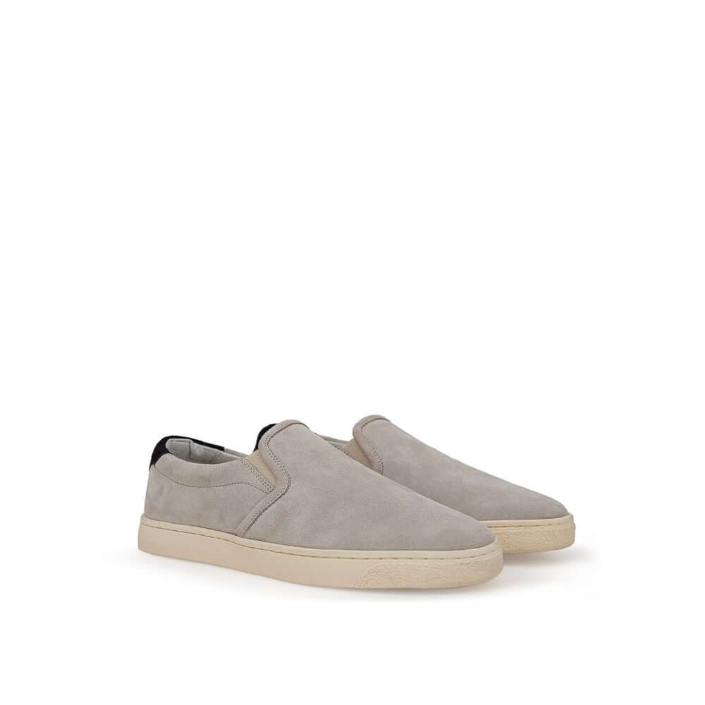 Brunello Cucinelli gray suede slip-on sneakers with white rubber soles and black back detail featuring gold 'Solomei' print.