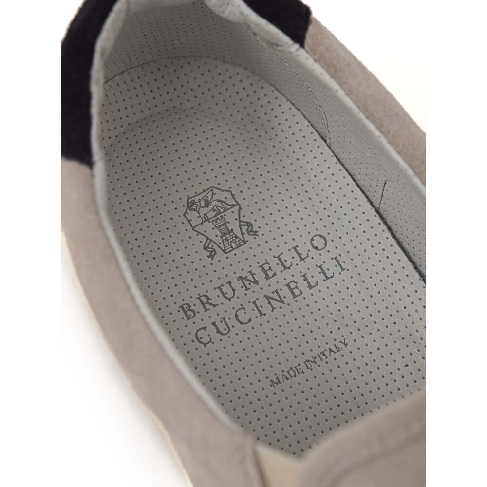 Brunello Cucinelli gray leather sneaker interior showing brand logo and 'Made in Italy' text on the insole.