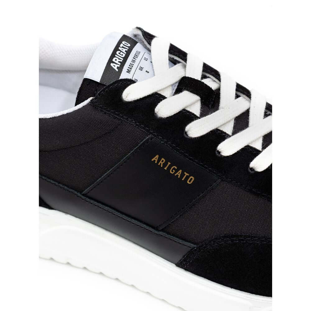 Axel Arigato Genesis Vintage Runner sneaker in black and white with leather and suede details, showcasing elegant retro design.