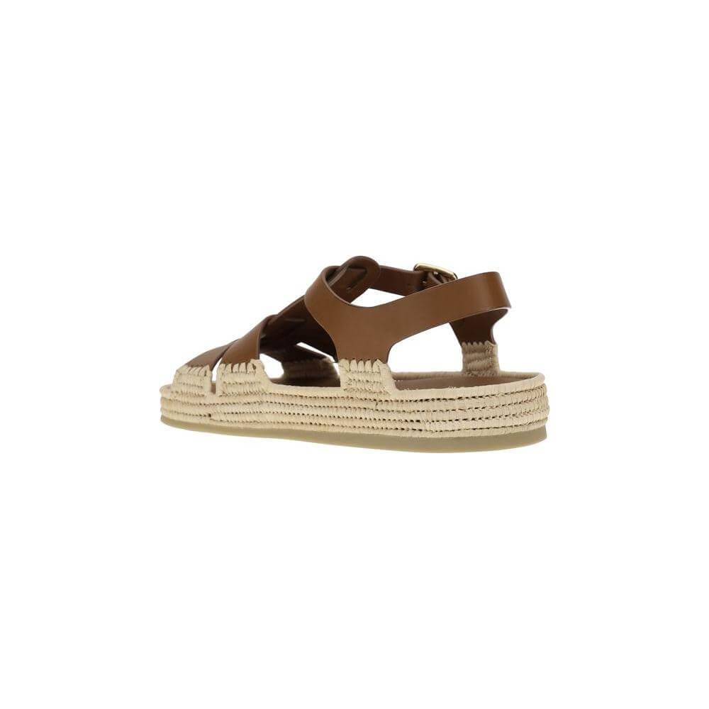 Prada leather and raffia sandals with adjustable strap, featuring woven raffia and leather contrast, retro-inspired design.