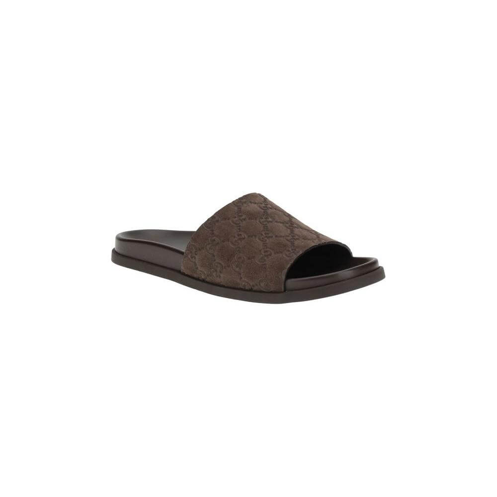 Gucci slider sandals with GG motif and suede upper, featuring a contoured sole for comfort and style. Ideal for elegant summer wear.