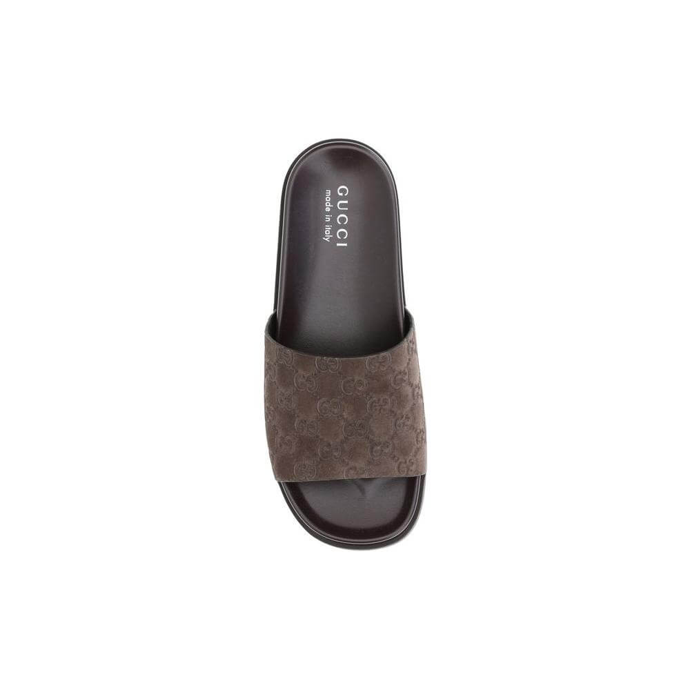 Gucci Slider Sandals with GG motif and suede upper, offering style and comfort with a contoured sole for a perfect summer look.