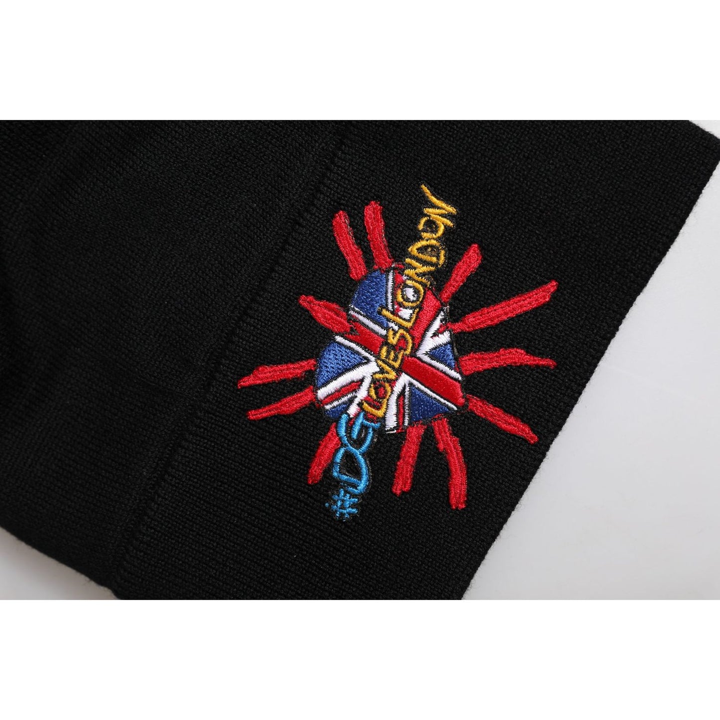 Dolce & Gabbana black knitted beanie hat with #DGLOVESLONDON logo, featuring a heart and rays design in vibrant colors.