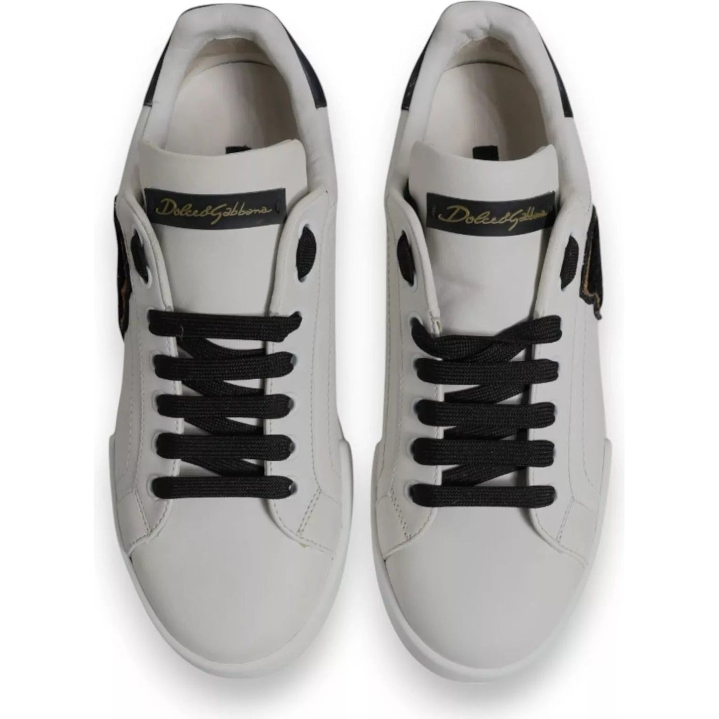 Top view of Dolce & Gabbana white leather low-top sneakers with black laces and DG logo, lightly preowned, made in Italy.
