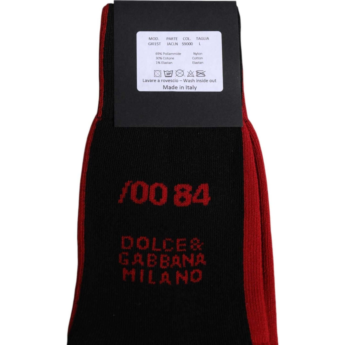 Dolce & Gabbana black nylon mid calf men's socks with red logo detailing, label showing fabric composition and care instructions, made in Italy.