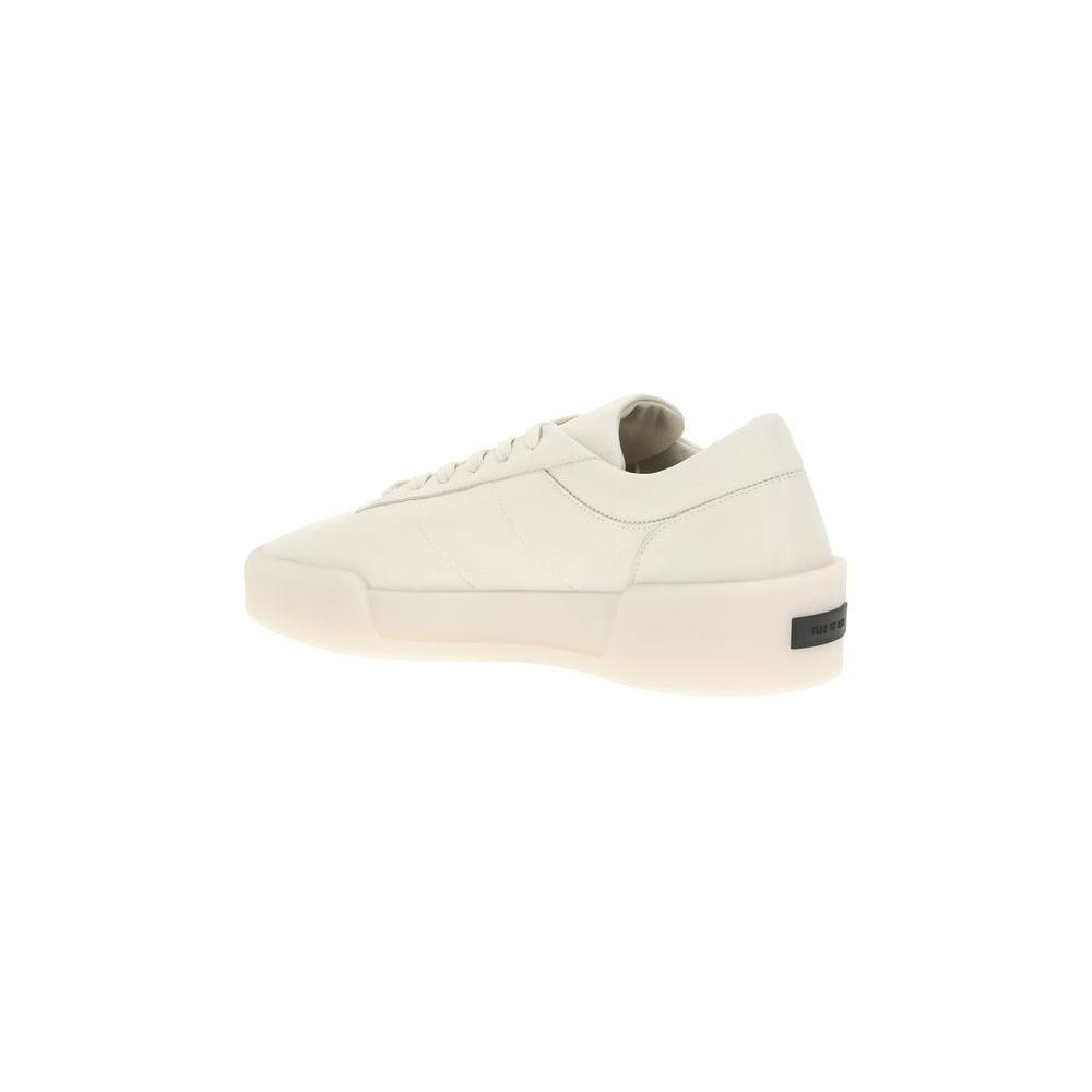 Fear of God Aerobic Low Sneakers with leather upper, elongated toe, and contrasting rubber sole in side view.