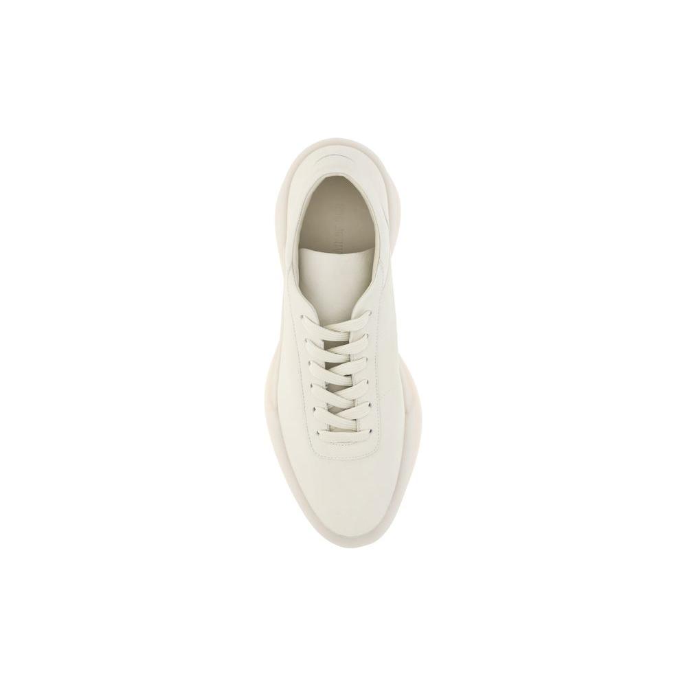 Top view of Fear of God Aerobic Low Sneakers in white leather featuring a minimal design with lace-up closure and rubber sole.