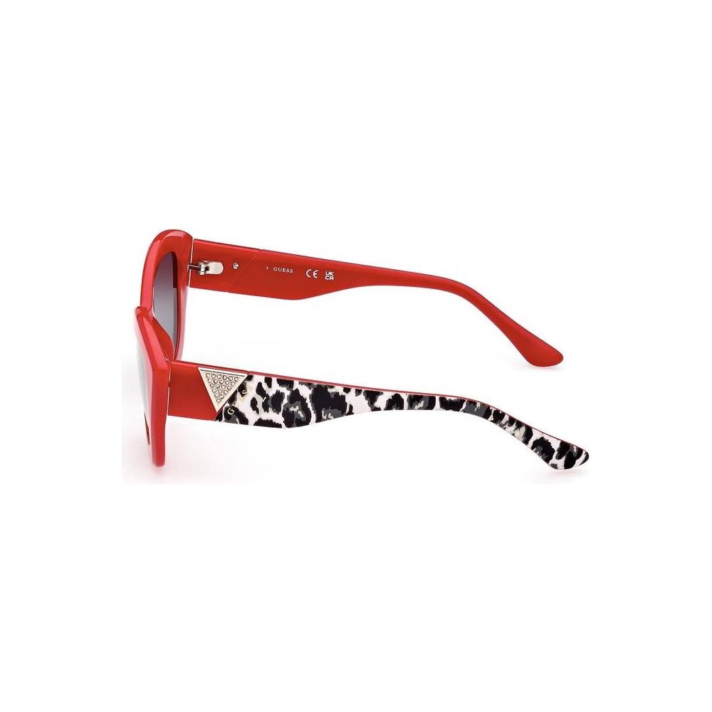 Guess Jeans red sunglasses with leopard print temples and black lenses, side view.