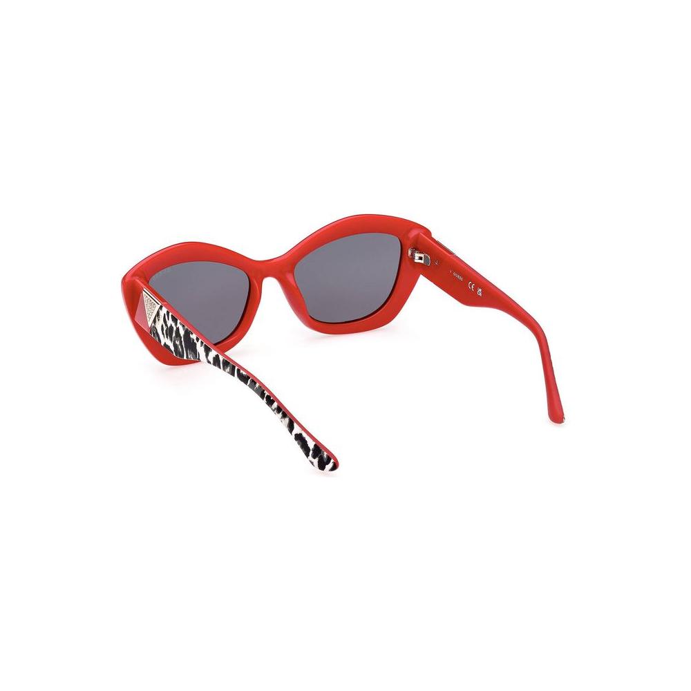Guess Jeans red injected women's sunglasses with black tinted teardrop lenses and stylish frame accents.