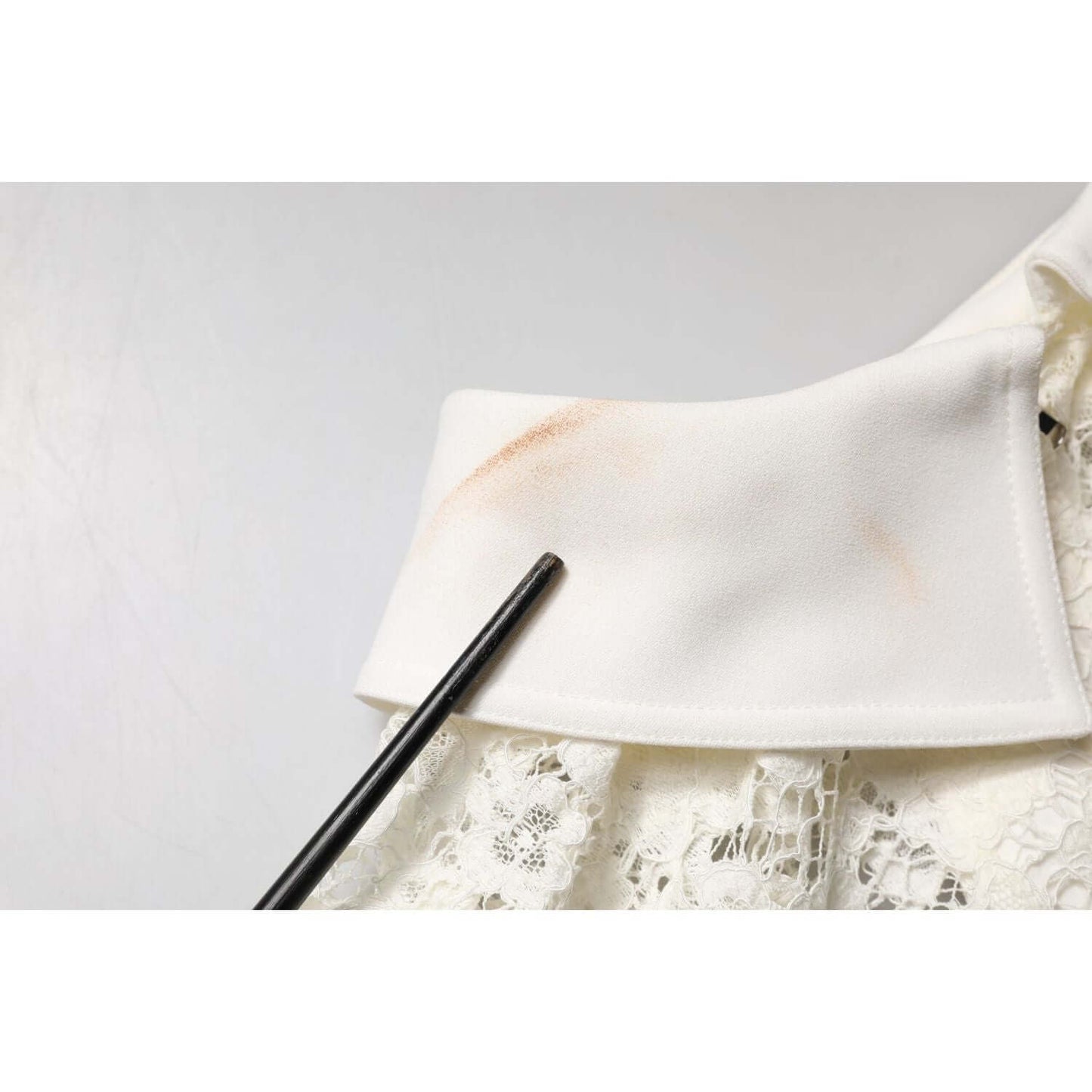 Close-up of makeup stain on Dolce & Gabbana white floral lace shift dress collar.