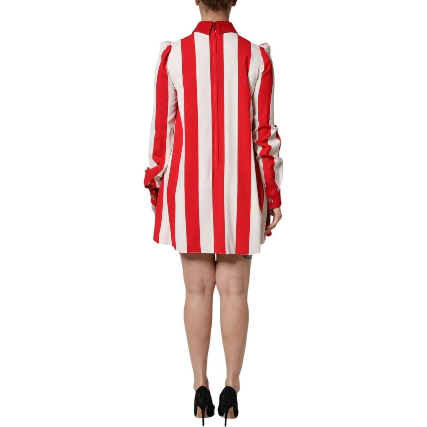 Back view of Dolce & Gabbana white and red striped mini dress with long sleeves, shown on a model wearing black heels.
