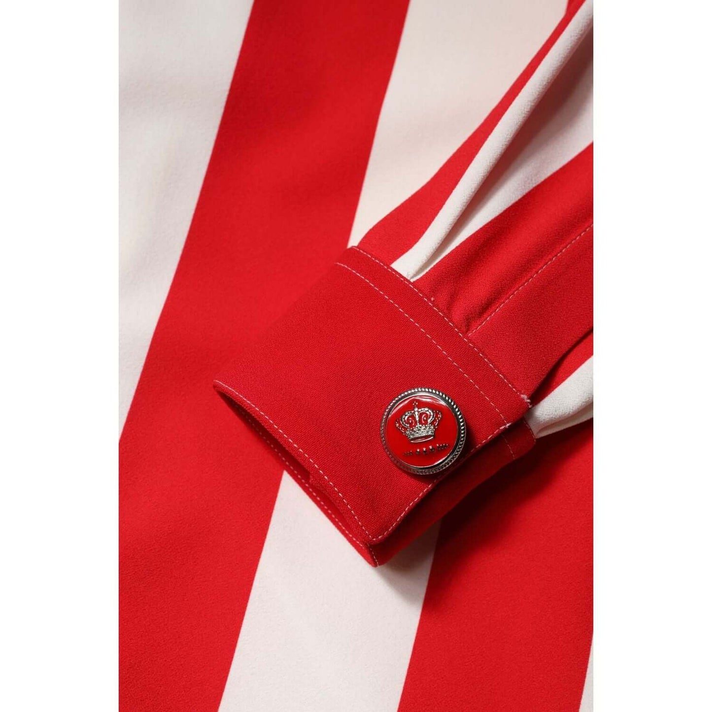 Close-up of Dolce & Gabbana white and red striped mini dress sleeve with button detail.
