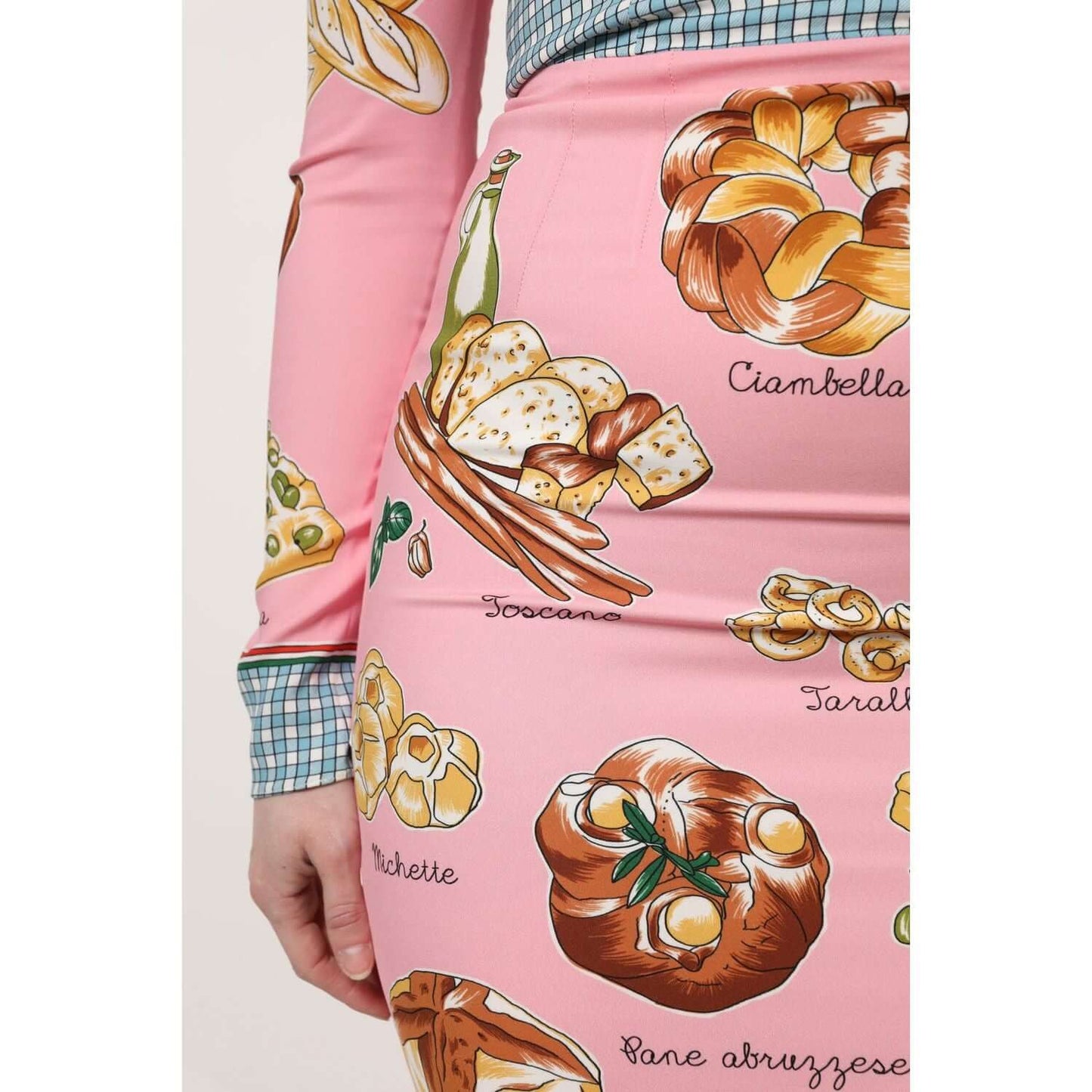 Close-up of Dolce & Gabbana pink pastry print bodycon midi dress showcasing food-themed pattern.