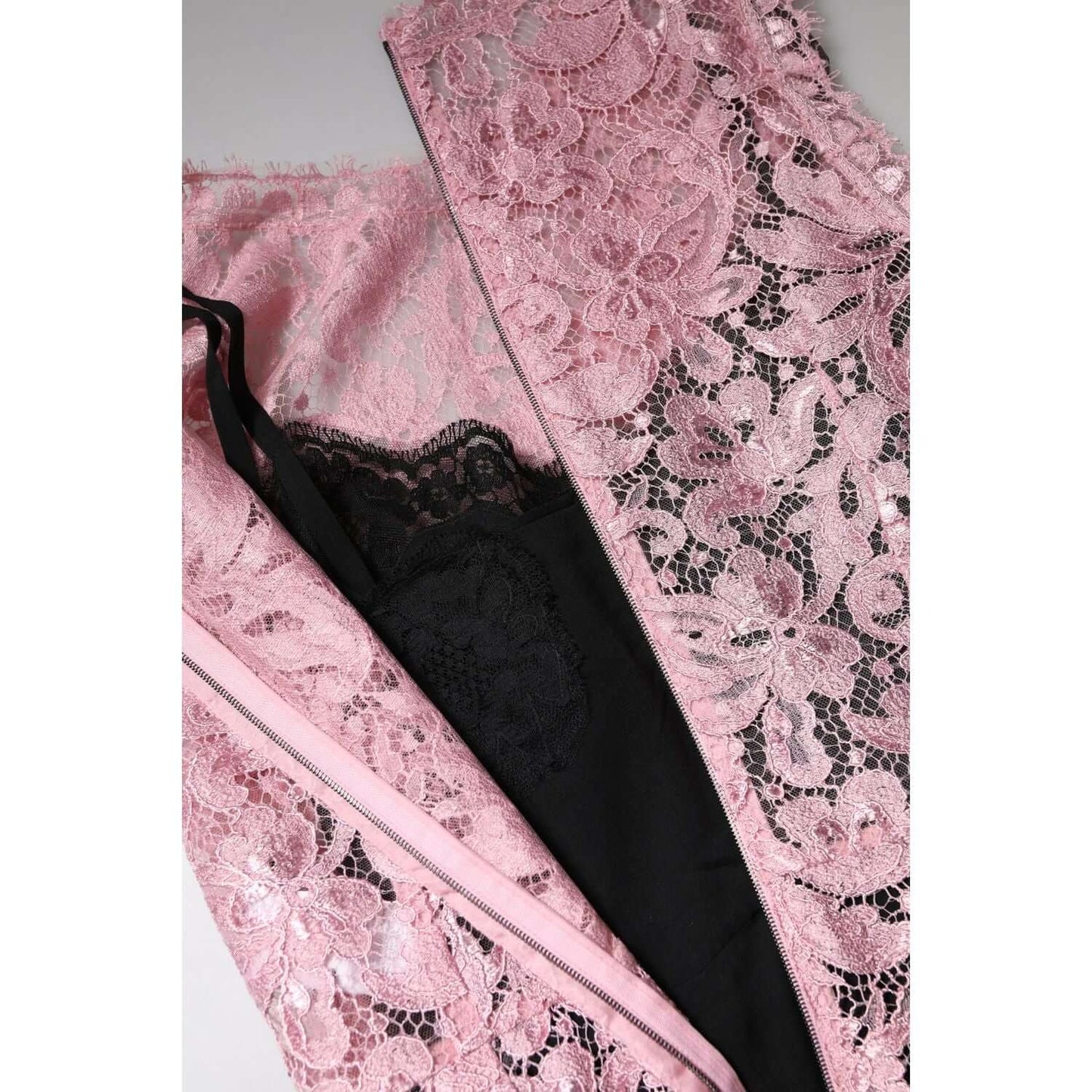 Close-up of Dolce & Gabbana pink floral lace sleeveless sheath dress with black lining and zipper closure, made in Italy.
