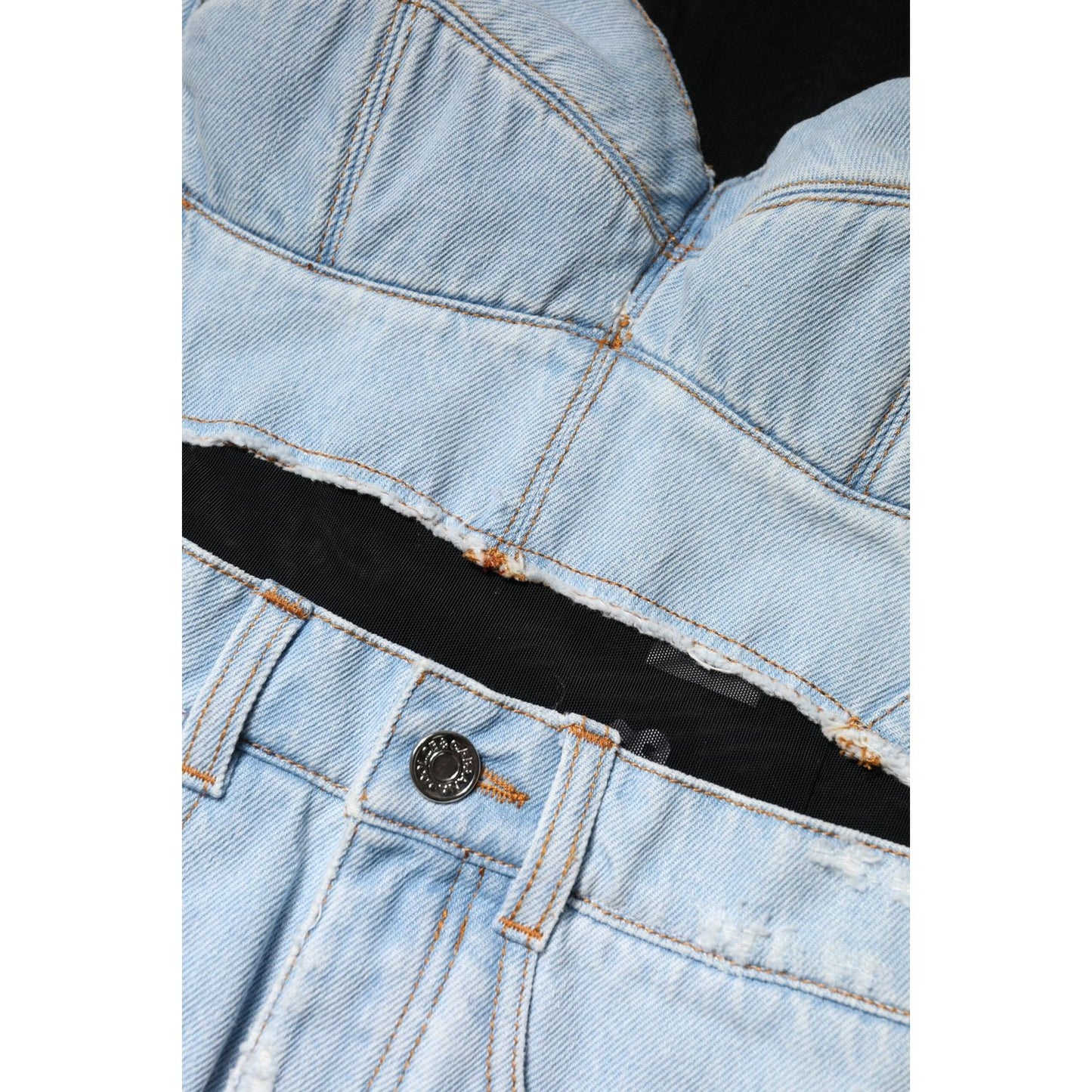 Close-up of a Dolce & Gabbana blue denim mini dress featuring a corset-style bodice and button detail on waistband.
