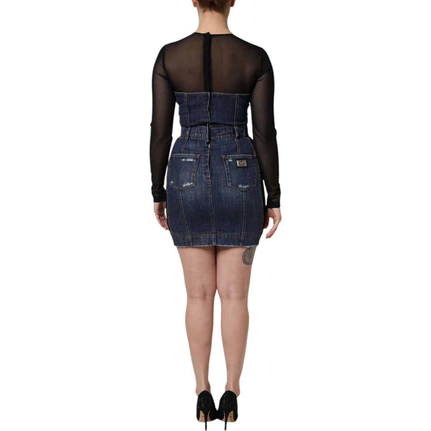 Back view of a Dolce & Gabbana black blue long sleeve denim mini dress showcasing its sheer sleeves and patch pocket details.