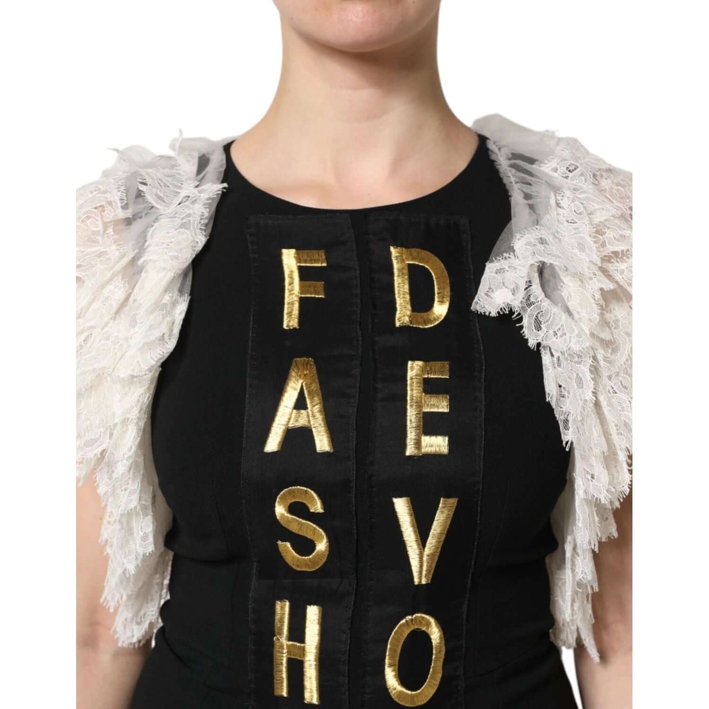 Dolce & Gabbana black mini dress with gold embellishments and lace, close-up of "Fashion Devotion" lettering, high-quality craftsmanship.