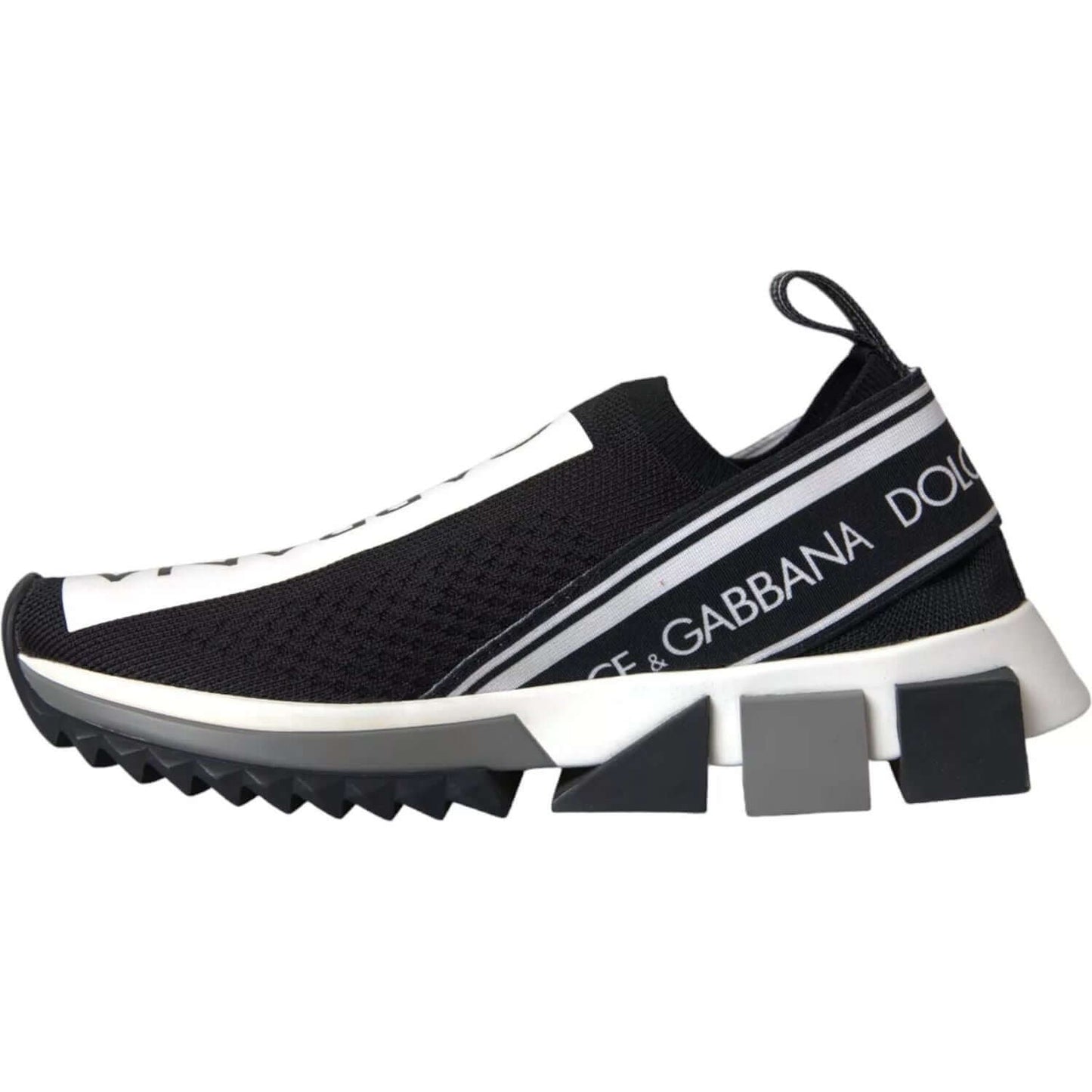 Dolce & Gabbana Sorrento slip-on sneakers in black and white with logo print and black rubber sole, side view.