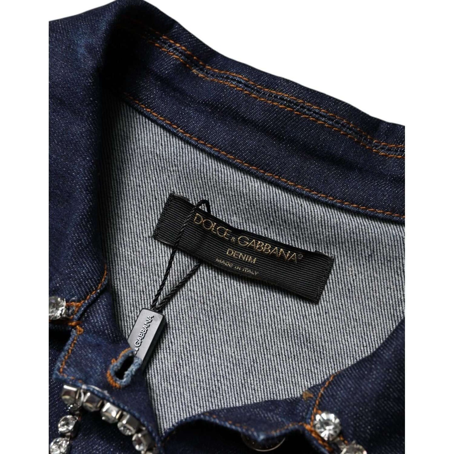Dolce & Gabbana blue denim jacket with crystal embellishments, close-up of label and button details.