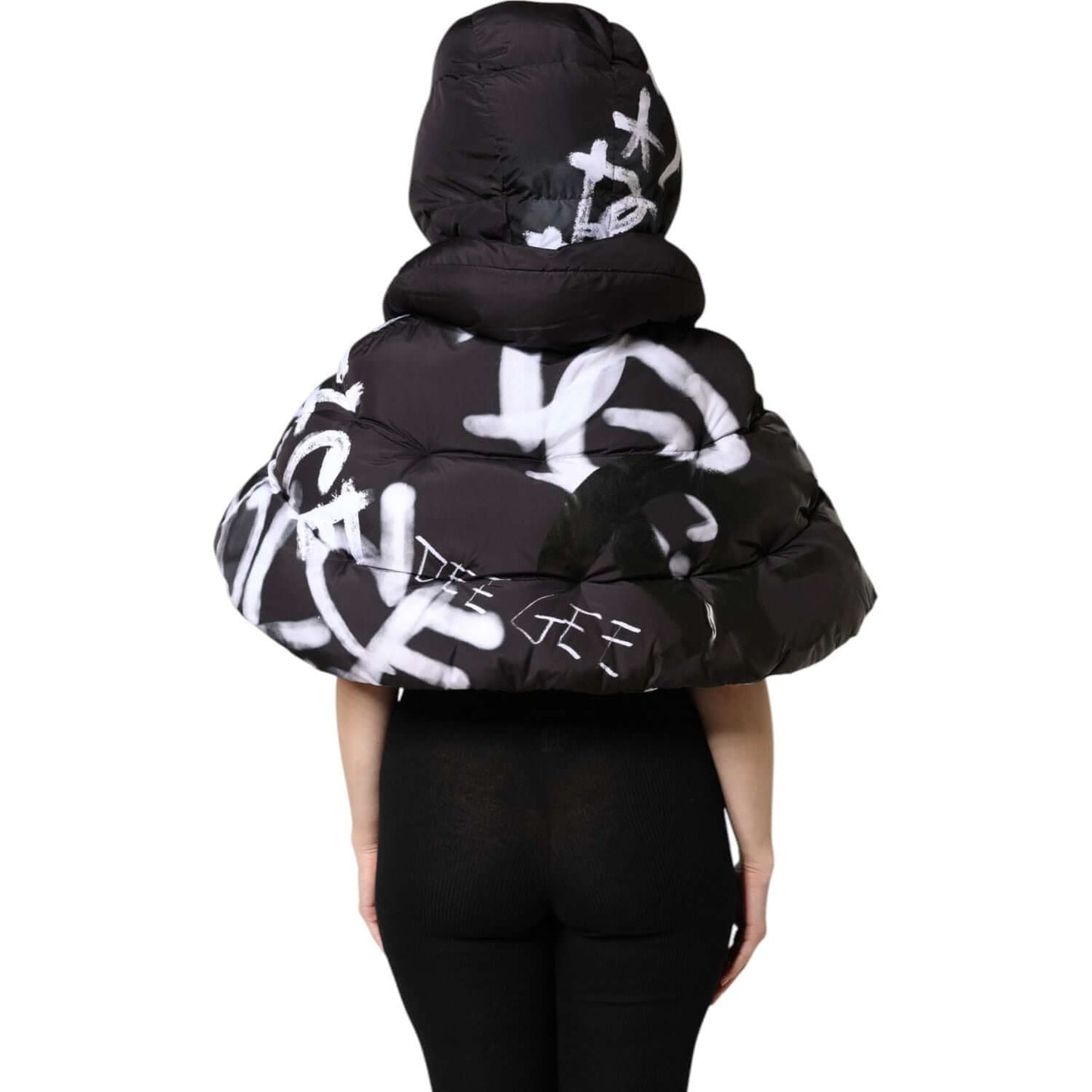 Back view of Dolce & Gabbana black padded hooded cropped jacket with graffiti design, showcasing stylish winter fashion.