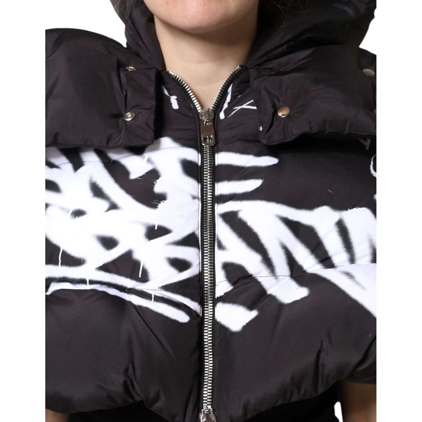 Dolce & Gabbana black padded hooded cropped jacket with white graphic detail and full zip front, showcasing luxury and style.